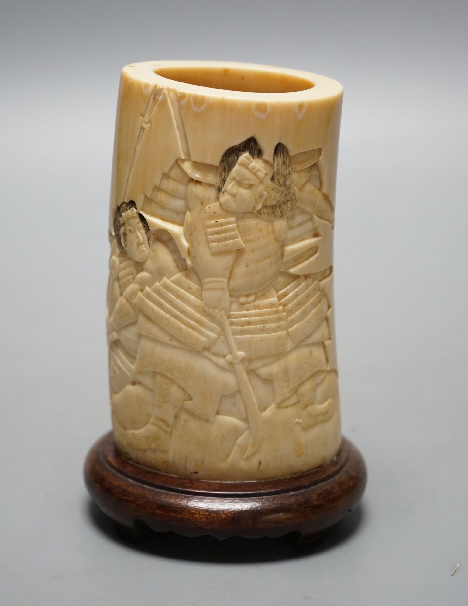 A Japanese Meiji period brush pot with samurai, 23 cms high including stand.